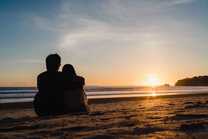 Two lovers and a beachcomber by the real sea